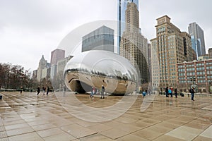 Cloud gate at Chicago Illinois Bean mirror art with people and buildings mirrored tourist landmark at this mayor USA city.