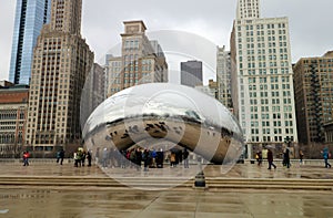 Cloud gate at Chicago Illinois Bean mirror art with people and buildings mirrored tourist landmark at this mayor USA city.