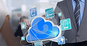 Cloud icon and network of digital icons against businessman and businesswoman shaking hands