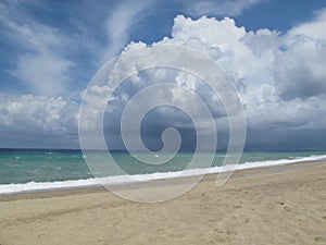 Cloud landscape. Cumulus clouds over the stormy sea on the beach. Italy, Calabria