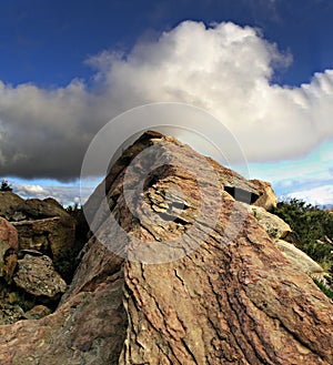 Cloud over rising rock