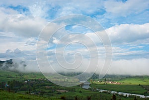 Cloud over the village. Morning fog. Giant cloud. Village in the Carpathians mountains.