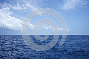 Cloud over wavy ocean in sunny day