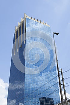 Cloud reflection on glass facade of building