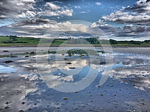 Cloud reflections on the beach