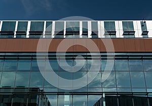 Cloud reflections in tall glass walls of an office building