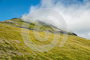 Cloud rolling across the peak of Beinn Dorain in Scottish Highlands.