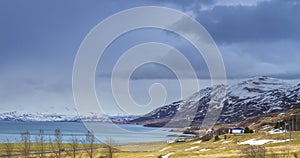 Cloud rolling time lapse over snow mountain fjords in Akureyri, Iceland.