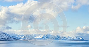 Cloud rolling time lapse over snow mountain fjords in Akureyri, Iceland.