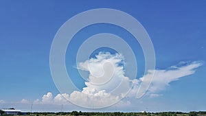 The cloud shape in the blue sky.