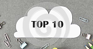 cloud shaped paper with text Top 10 on dark stylish