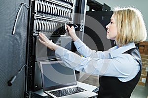 Cloud storage service. female engineer replacing hard drive in server