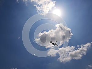 Cloud, sun, blue sky and airplane