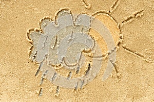 Cloud and sun drawing in sand