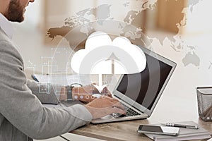 Cloud technology. Businessman using laptop at table