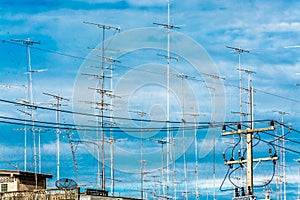 Cloud of television antena in the blue sky.