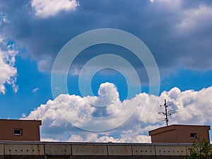 Cloud - towering cumulus - forming in the distance above the roof of the house