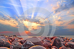 Cloudburst sun rays at sunset on whitstable beach