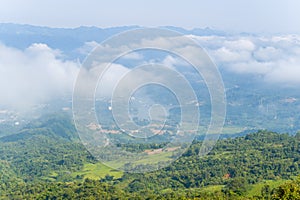 The clouds above the city seen at the green mountains , in Asia, Vietnam, Tonkin, Dien Bien Phu, in summer, on a sunny day