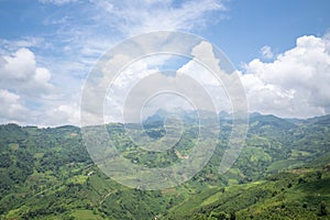 The clouds above the city seen at the green mountains , in Asia, Vietnam, Tonkin, Dien Bien Phu, in summer, on a sunny day