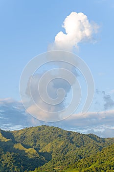 The clouds above the city seen at the green mountains , in Asia, Vietnam, Tonkin, Dien Bien Phu, in summer, on a sunny day