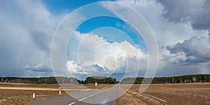 Clouds above the road, spring roads.