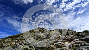 Clouds above a rocky hill