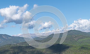 Clouds above rolling green mountains photo