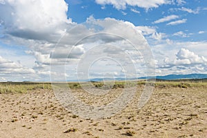 Clouds above the sandy plain near Mongolia. Tyva. Steppe. Sunny summer day