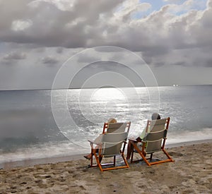 The clouds allow the full moon rays to penetrate to the ocean waves