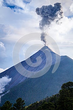 Clouds and ash mix together as Volcano Fuego erupts by daylight