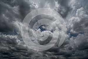 Clouds with background,sunlight through very dark clouds background of dark storm cloud