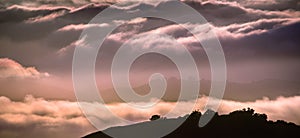 Clouds bathed in the sunset light covering rolling hills, south San Francisco bay area, California