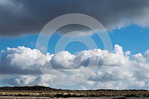 Clouds in a beautiful cloud formation above the dunes