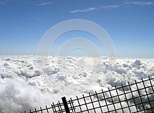 Clouds behind a fence