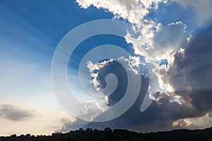 Clouds in blue sky on background sunrise and Sun rays