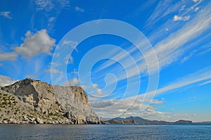 Clouds on a blue sky, the beautiful rocky mountains on the shores of the Black sea in Crimea.