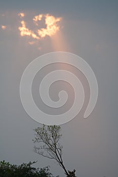 Clouds and a blue sky and sunbeam shining through