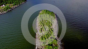 Clouds casting shadow over islet in lake