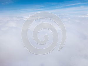 Clouds and clear bright blue sky. Aerial view from plane illuminator