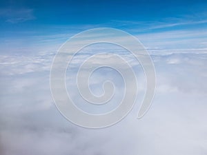 Clouds and clear bright blue sky. Aerial view from plane illuminator