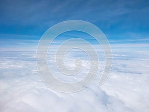 Clouds and clear bright blue sky. Aerial view from plane illuminator