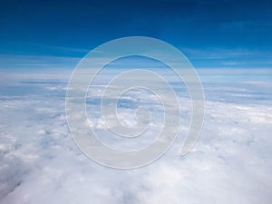 Clouds and clear bright blue sky. Aerial view from plane illuminator