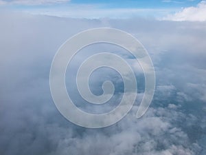 Clouds and clear bright blue sky. Aerial view from plane illuminator