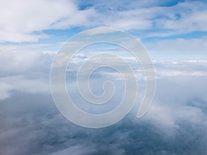 Clouds and clear bright blue sky. Aerial view from plane illuminator