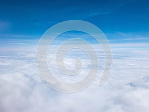 Clouds and clear bright blue sky. Aerial view from plane illuminator