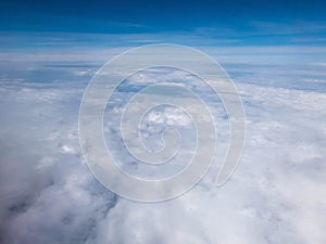 Clouds and clear bright blue sky. Aerial view from plane illuminator