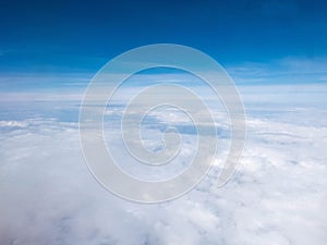 Clouds and clear bright blue sky. Aerial view from plane illuminator