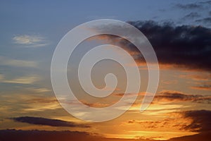 Clouds colored by setting sun on summer evening