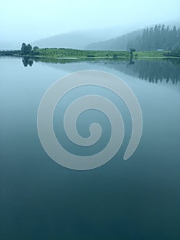 Clouds covered the mirror-like surface of the blue lake